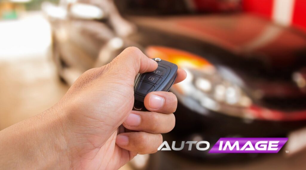 and holding a remote car starter key fob in front of a vehicle, Auto Image