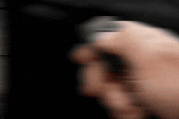 Hand pressing a button on a key fob to activate a remote start system, illustrating how a remote start system works to start a vehicle from a distance.