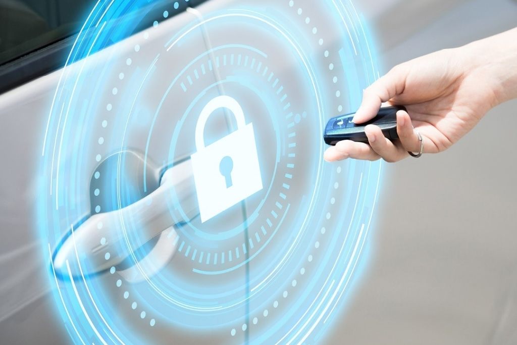 A person holds a remote key fob near a car door with a digital lock icon and circular interface effect overlayed, symbolizing secure vehicle access and remote start technology. This visual supports Auto Image’s overview of remote start pricing in New Jersey based on vehicle type and system features.
